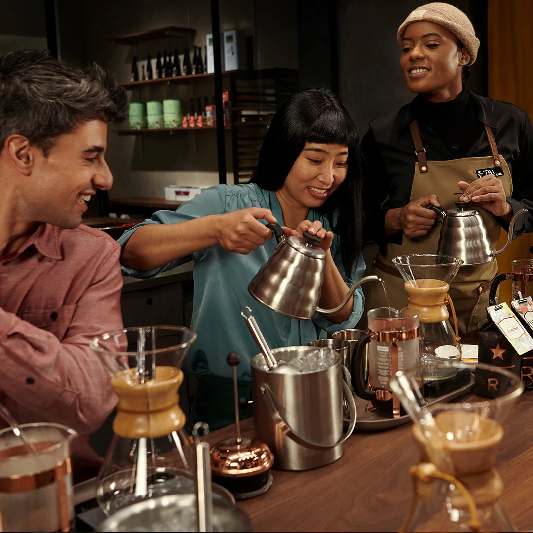 Photograph of a barista serving guests.