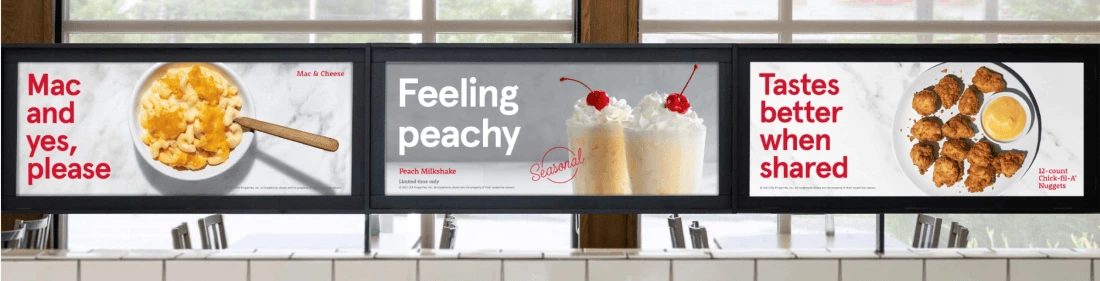 Three in-store menu displays featuring macaroni and cheese, peach milkshakes and nuggets